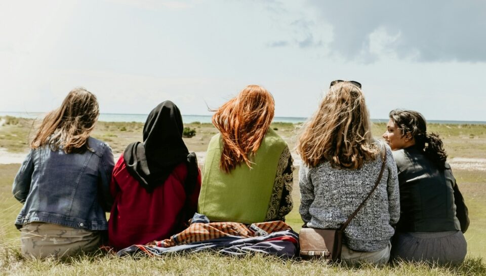 alvin-sadewo-D4k00sUDjzk-unsplash group of people sitting on grass field during daytime