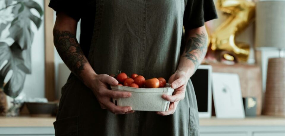 woman holding tomatoes