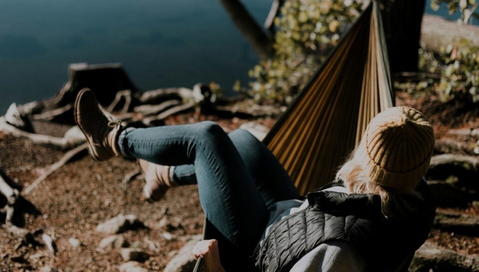 priscilla-du-preez-M1G2lWw9j3U-unsplash woman sitting on hammock beside calm water