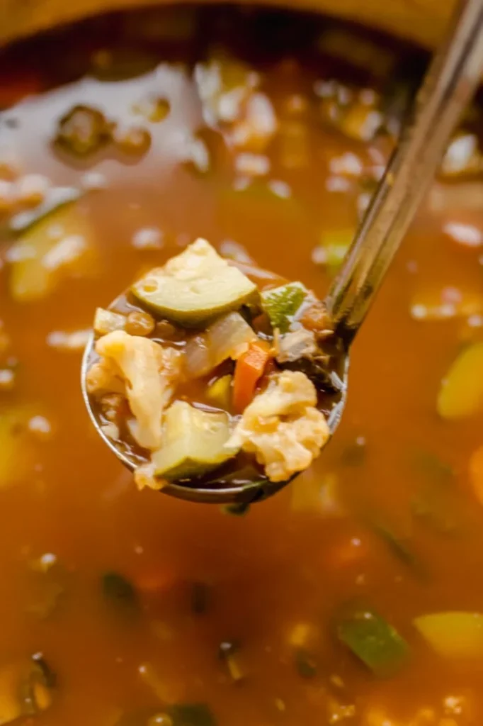 overhead shot of a bowl of soup with a ladle taking a spoonful out